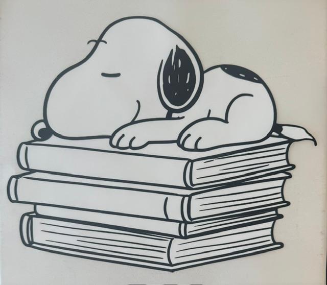 Snoopy - Laying on books