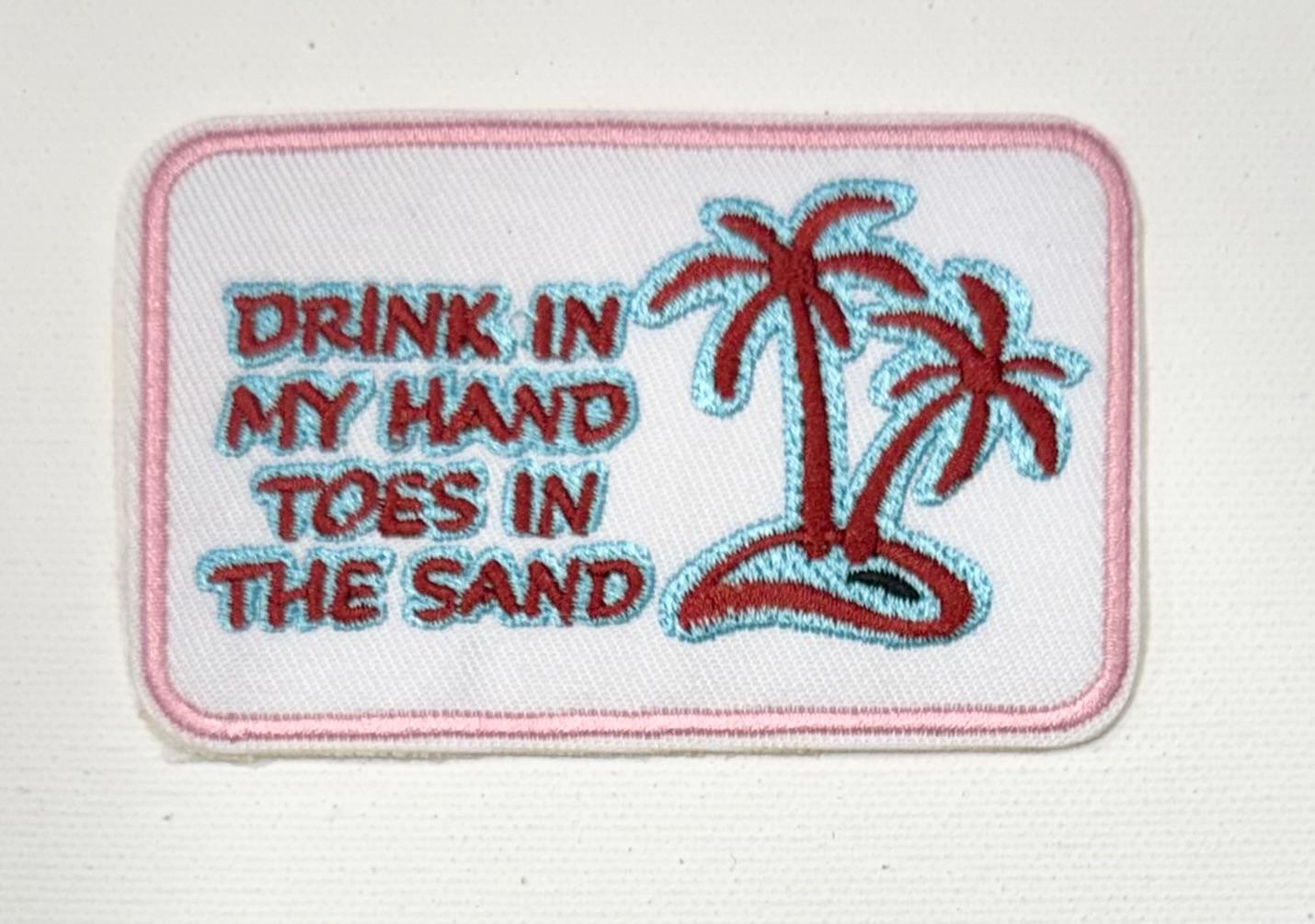 Drink in hand, toes in sand hat patch