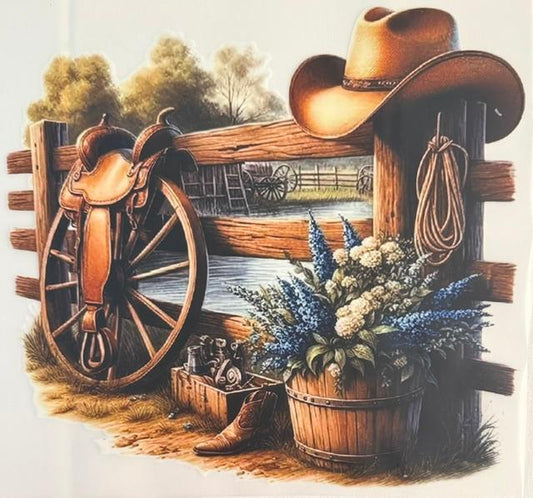 Western scene, wagon wheel with saddle